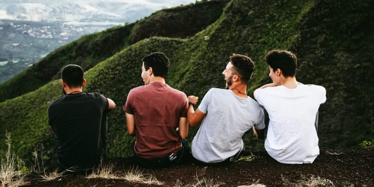 Four young men sitting in hills